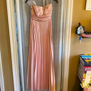 Long pink pleated dress with flower detail